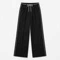 Black wide-leg cropped pants with white side piping and a white drawstring waist, shown flat on a light gray background.